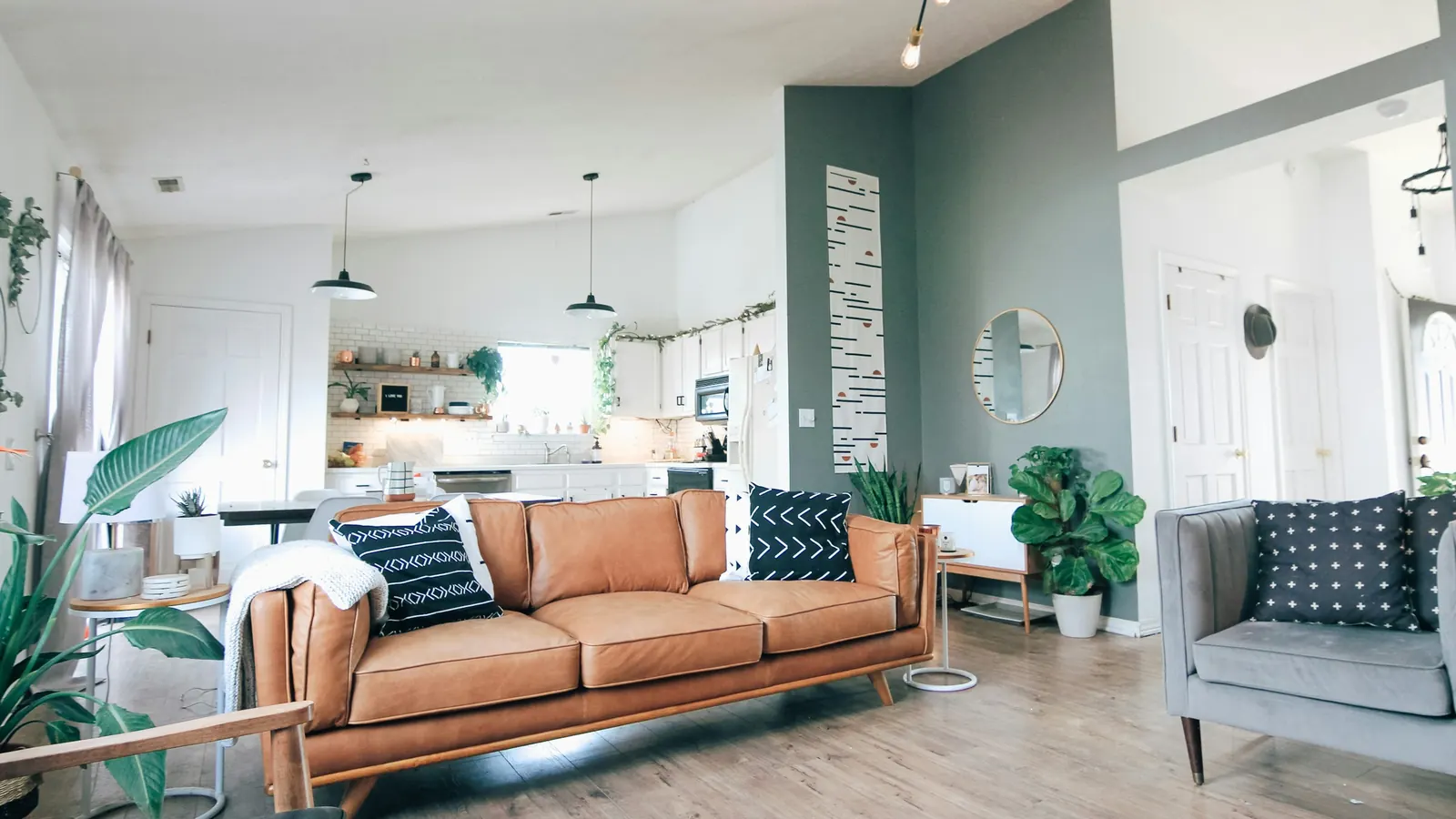 Bright, fully furnished corporate housing apartment with a sofa, dining area and open-plan kitchen