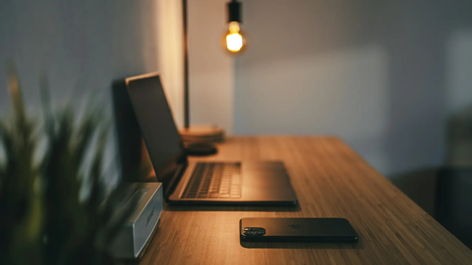 Dedicated home workspace with laptop and desk lamp in a furnished corporate apartment
